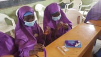 Hafsat and Aisha learn a new skill, bead making; Photo by Stella Abah