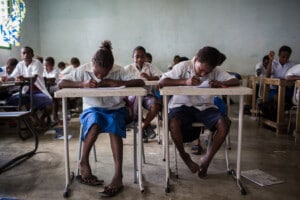 Grade 7 students complete classwork; Photo by DFAT photo library